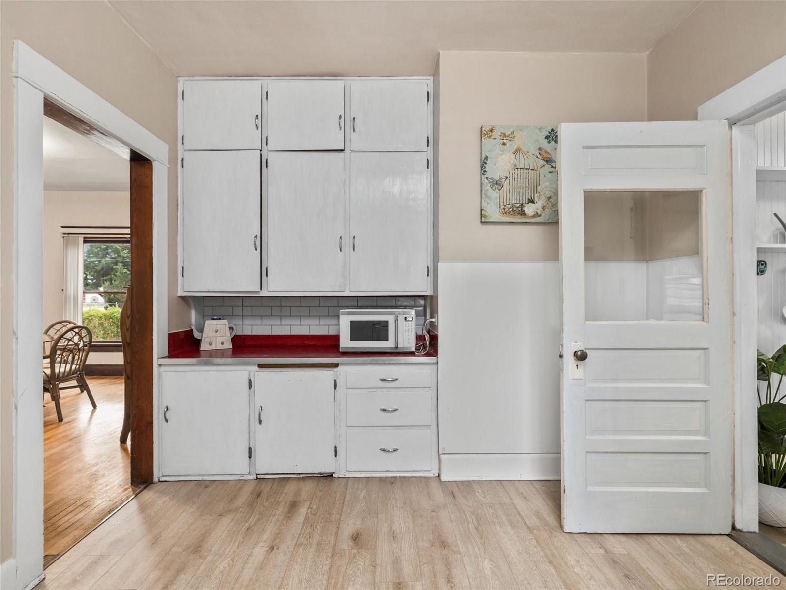 708 7th Street Fowler, CO 81039 - Photo 15 of 17 a view of kitchen with cabinets and wooden floor