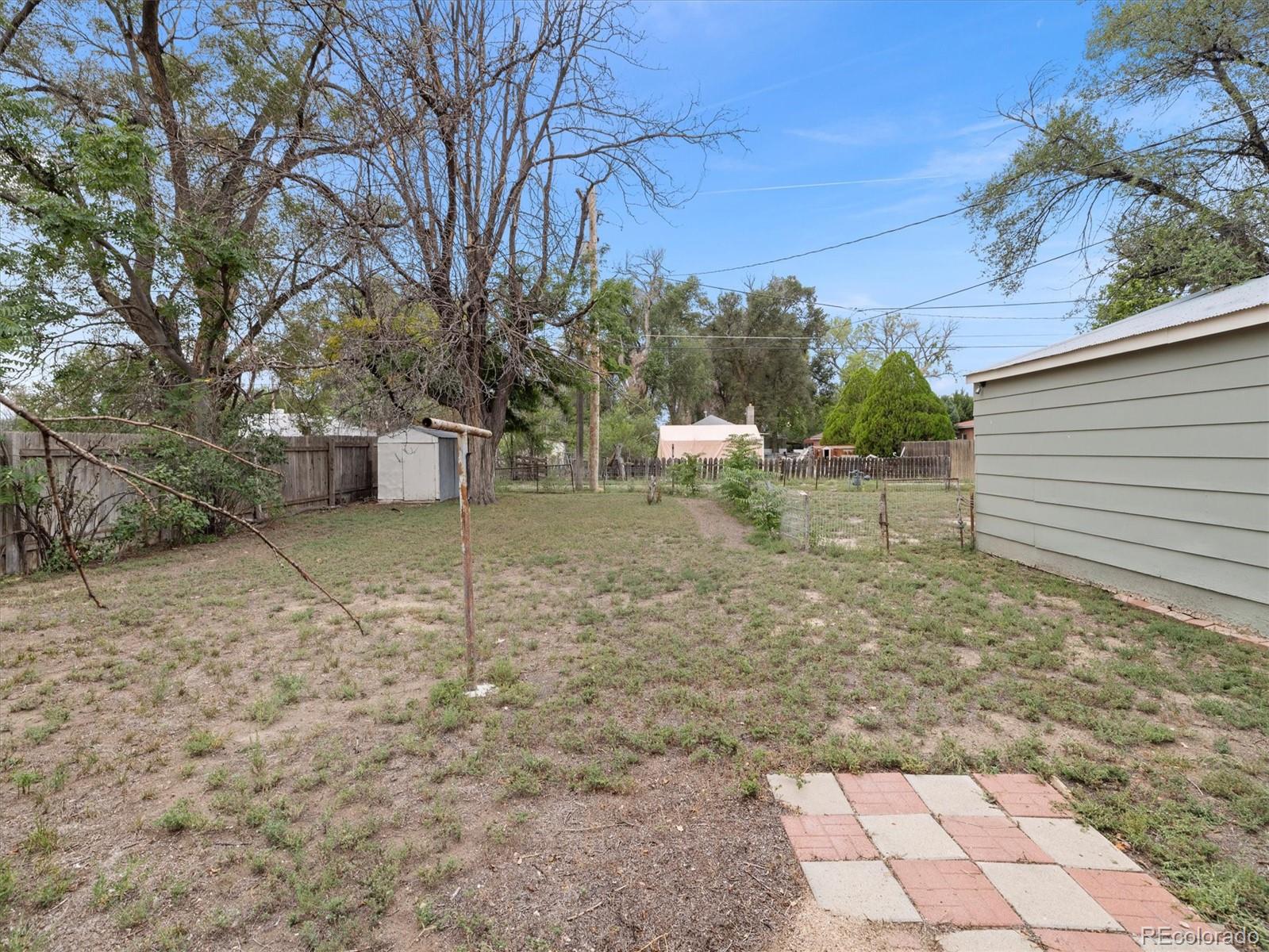 708 7th Street Fowler, CO 81039 - Photo 6 of 17 a view of a backyard with large trees