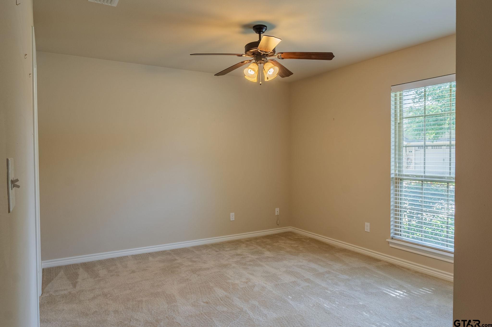 421 West Cumberland Road, Unit 703 Tyler, TX 75703 - Photo 14 of 29 an empty room with windows and fan