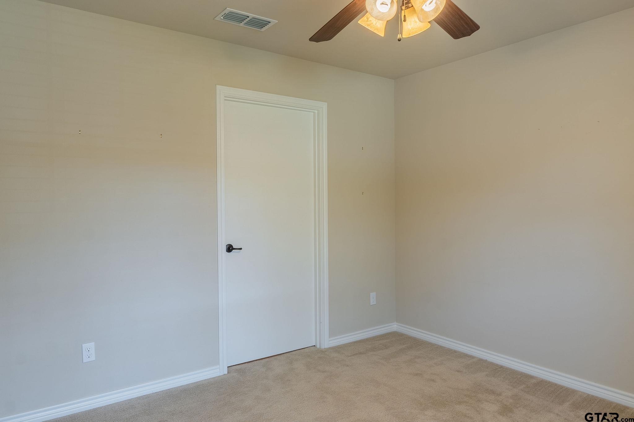 421 West Cumberland Road, Unit 703 Tyler, TX 75703 - Photo 17 of 29 an empty room with a chandelier fan