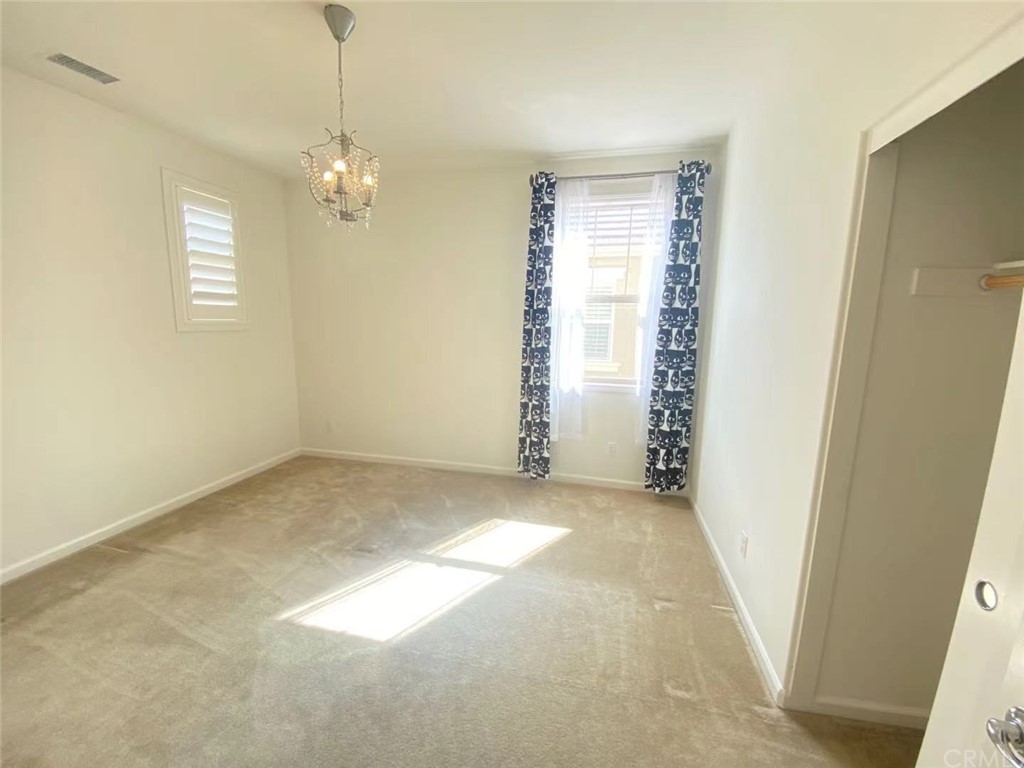 149 Allium Irvine, CA 92618 - Photo 16 of 26 en empty room with windows and entrance