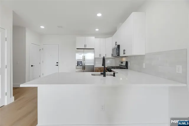 a view of kitchen with refrigerator and window