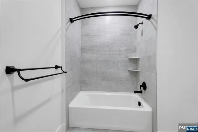 a bathroom with a bath tub and a shower