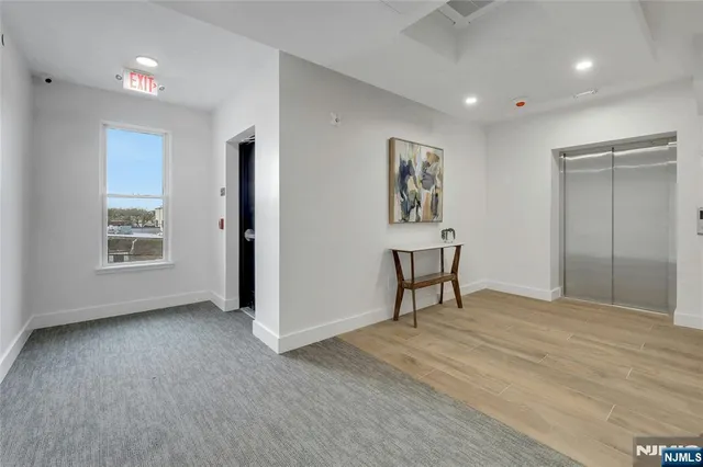 a view of an empty room with window and closet