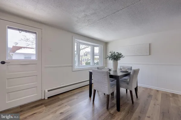 a dining room with furniture and window