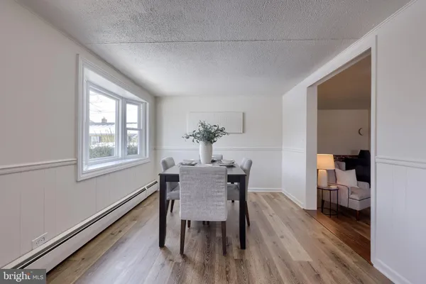a dining room with furniture and wooden floor