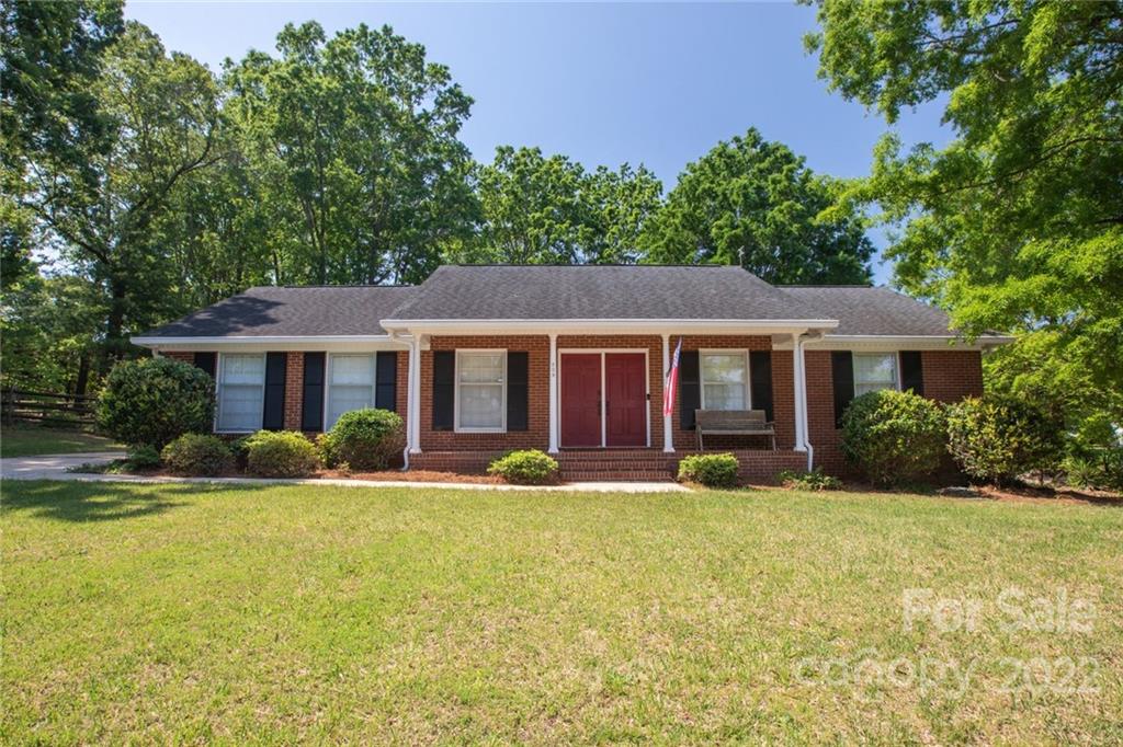 209 Fallingtree Lane Monroe, NC 28112 - Photo 2 of 22 a front view of a house with swimming pool and porch