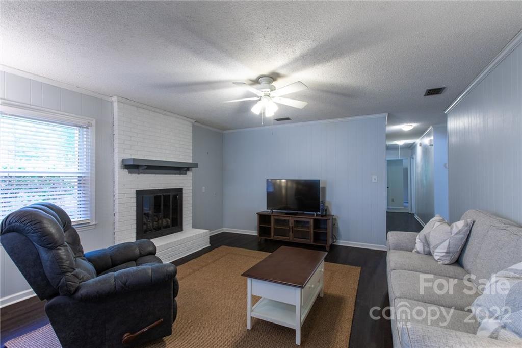 209 Fallingtree Lane Monroe, NC 28112 - Photo 6 of 22 a living room with furniture a fireplace and a flat screen tv