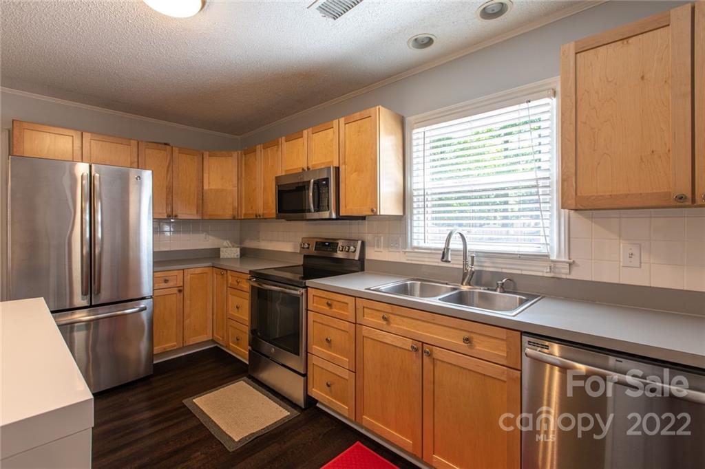 209 Fallingtree Lane Monroe, NC 28112 - Photo 9 of 22 a kitchen with stainless steel appliances granite countertop a refrigerator sink and microwave