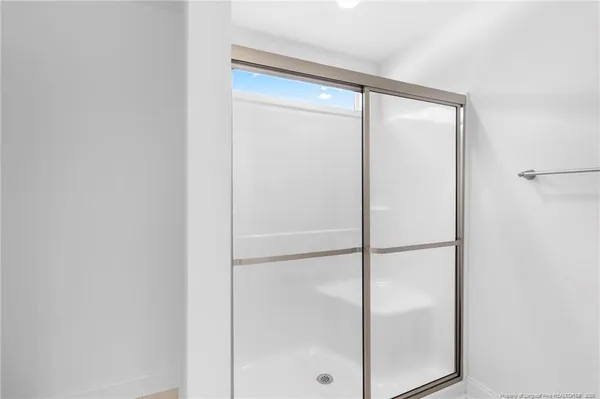 a bathroom with a glass shower door