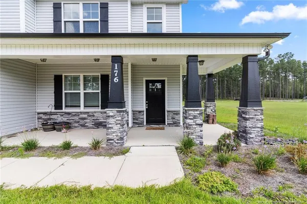 a front view of a house with garden and patio