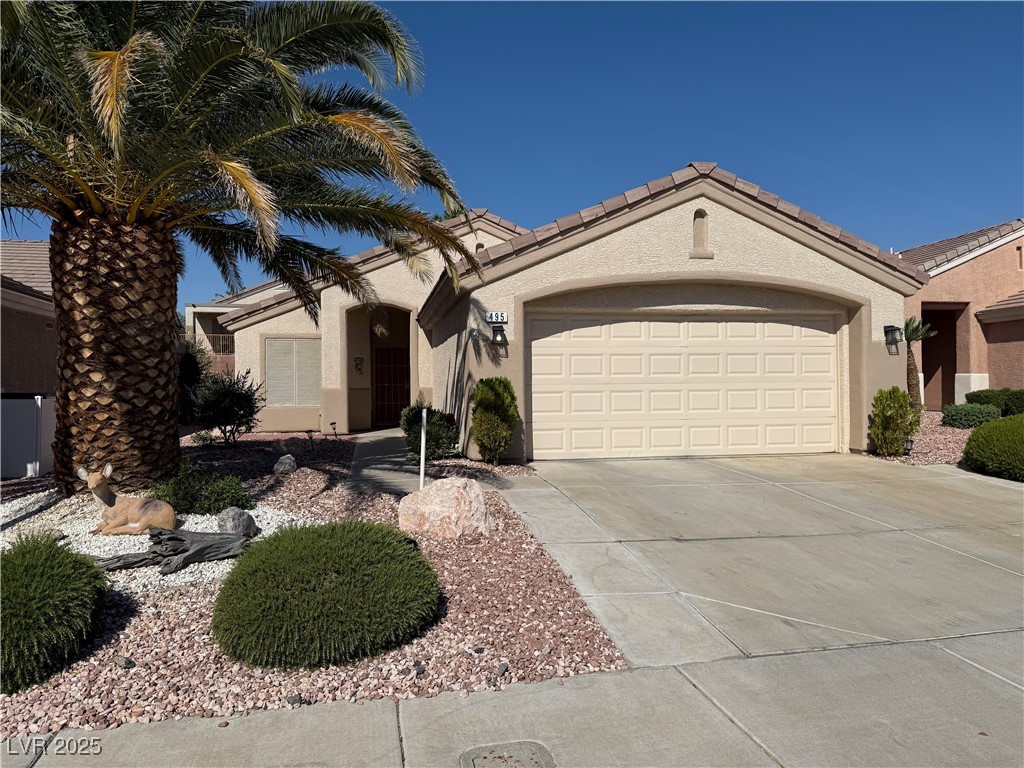 495 Edgefield Ridge Place Henderson, NV 89012 - Photo 1 of 16 Ranch-style house with driveway, a garage, and stucco siding