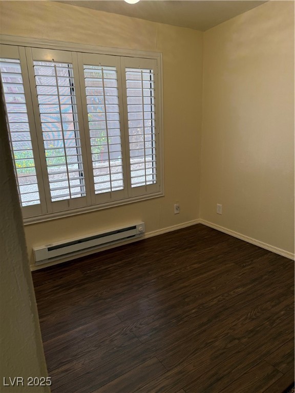 495 Edgefield Ridge Place Henderson, NV 89012 - Photo 3 of 16 Unfurnished room featuring baseboard heating and dark wood-type flooring