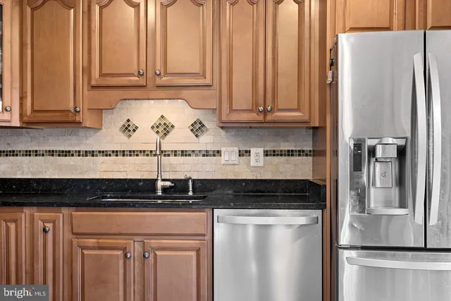 a kitchen with a refrigerator and cabinets