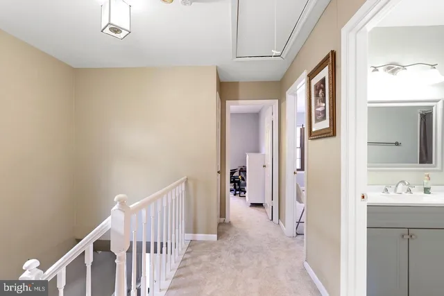 a view of a hallway with closet and wooden floor
