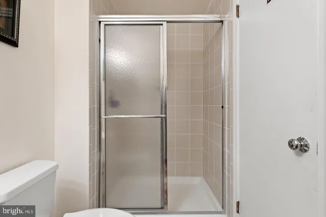 a bathroom with a glass shower door