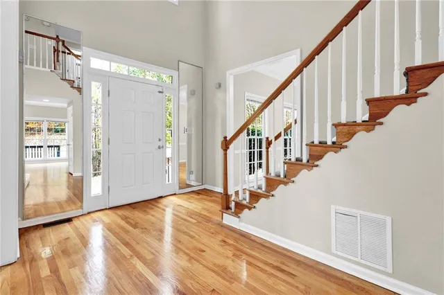 a view of an entryway with wooden floor and door