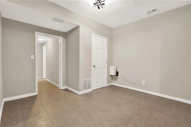 an empty room with closet and windows