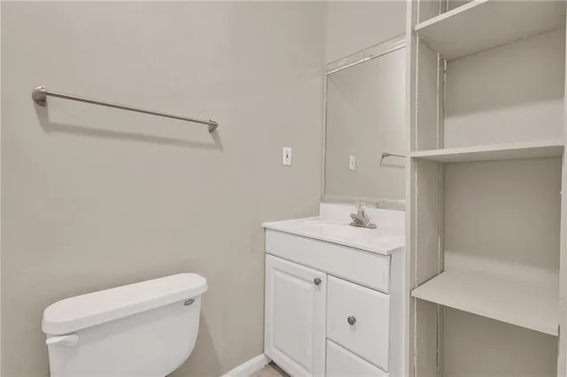 a bathroom with a sink a toilet and vanity
