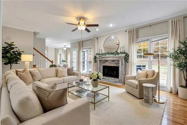 a living room with furniture fireplace and a large window