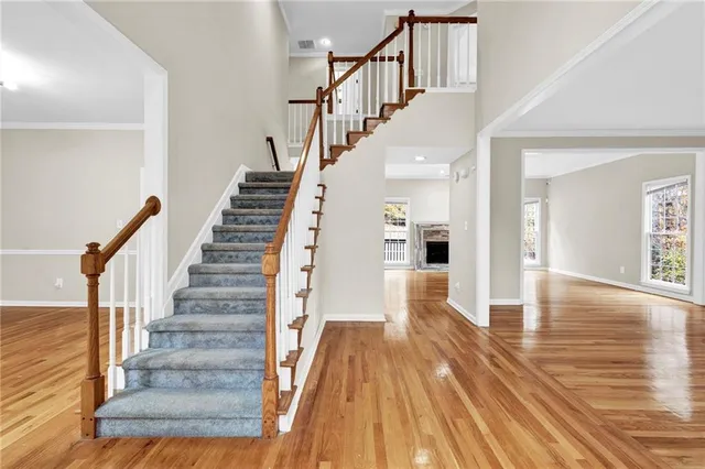 a view of entryway and hall with wooden floor