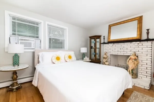 a bedroom with a bed a table and chair