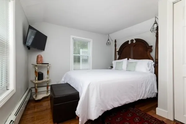 a bedroom with a bed and a television