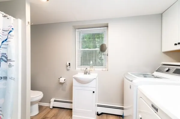 a bathroom with a sink toilet and window