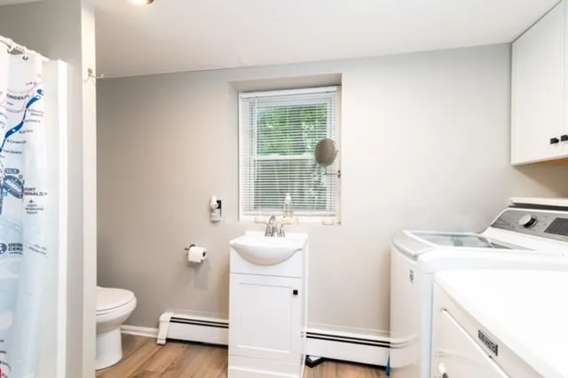 a bathroom with a sink toilet and window
