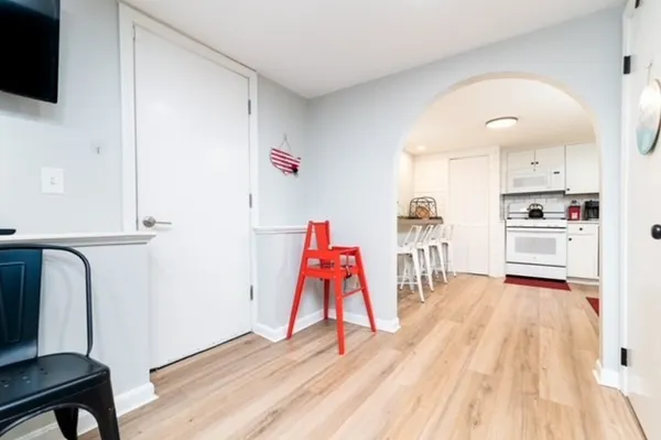 a view of a room with wooden floor and furniture