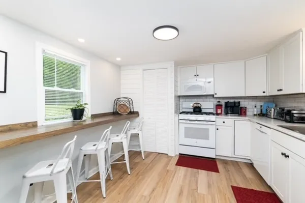 a kitchen with a sink a stove and cabinets