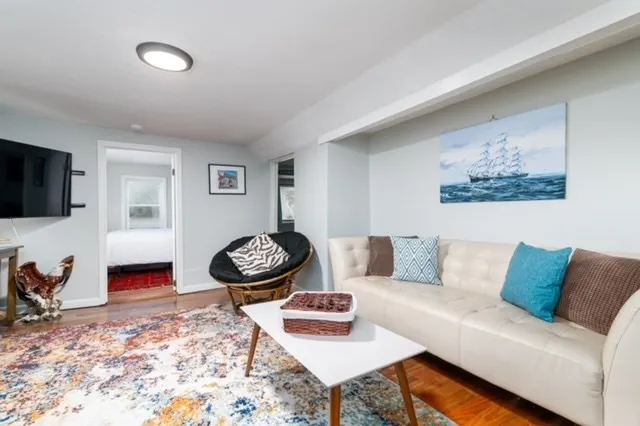 a living room with furniture and a flat screen tv