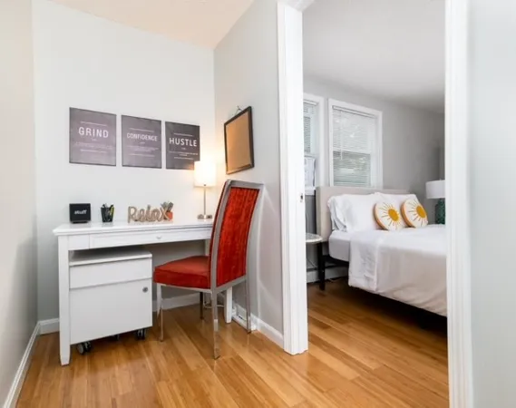 a bedroom with furniture and a wooden floor