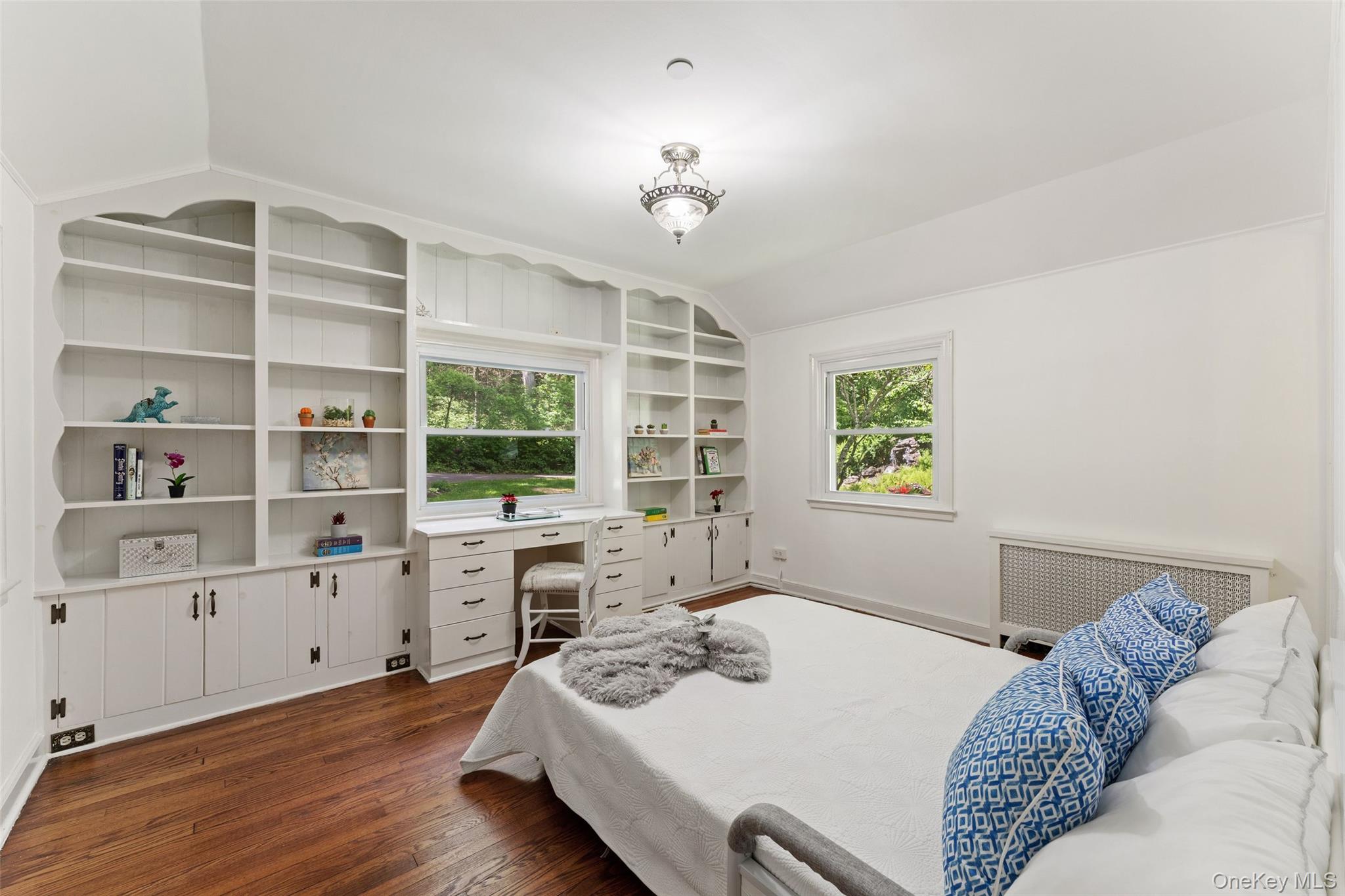 25 Cabin Ridge Road Chappaqua, NY 10514 - Photo 13 of 39 Another bedroom featuring extensive built-in white shelving and wood-finish flooring
