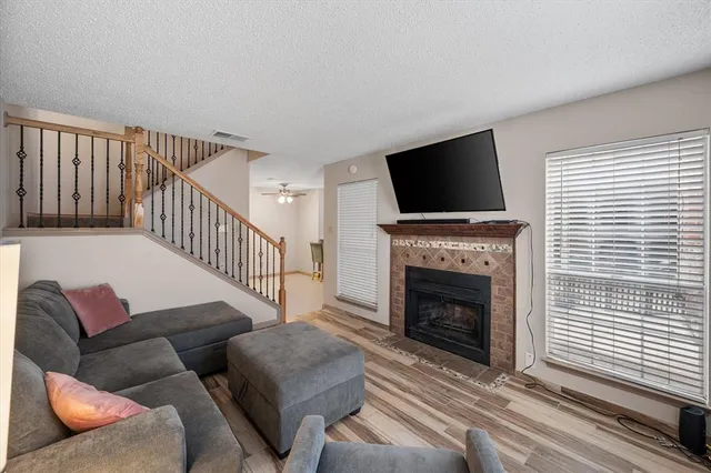 a living room with furniture a flat screen tv and a fireplace