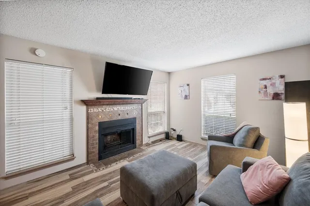 a living room with furniture a fireplace and a flat screen tv