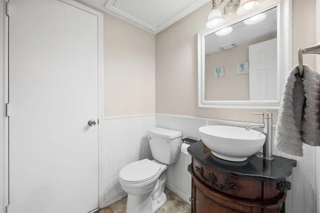 a bathroom with a sink toilet and mirror