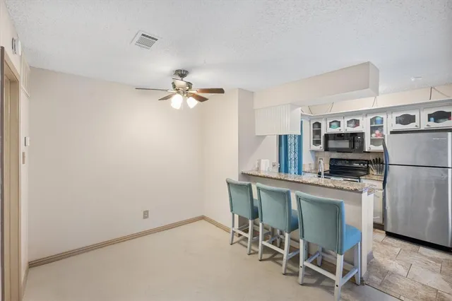 a kitchen with stainless steel appliances a refrigerator and a stove top oven