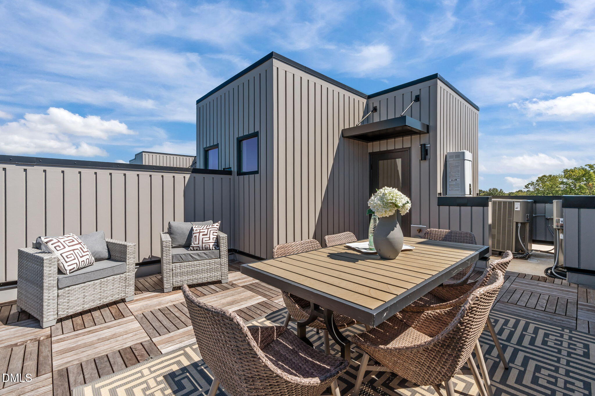 a view of a roof deck with furniture
