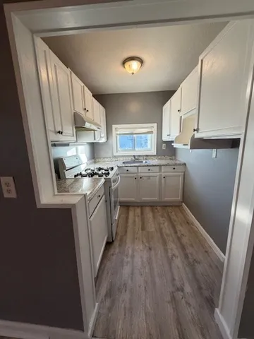 a kitchen with a sink a refrigerator and window