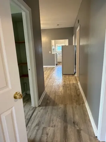a view of livingroom with hardwood floor and front door
