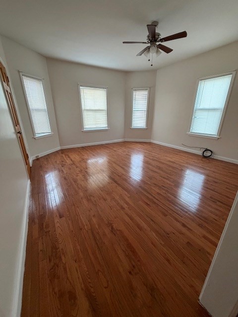 137 Tecumseh Street, Unit 2 Fall River, MA 02721 - Photo 3 of 11 wooden floor in an empty room with a window