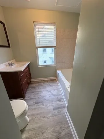 a bathroom with a sink a toilet and tub