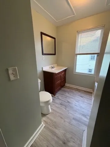 a bathroom with a toilet sink and mirror