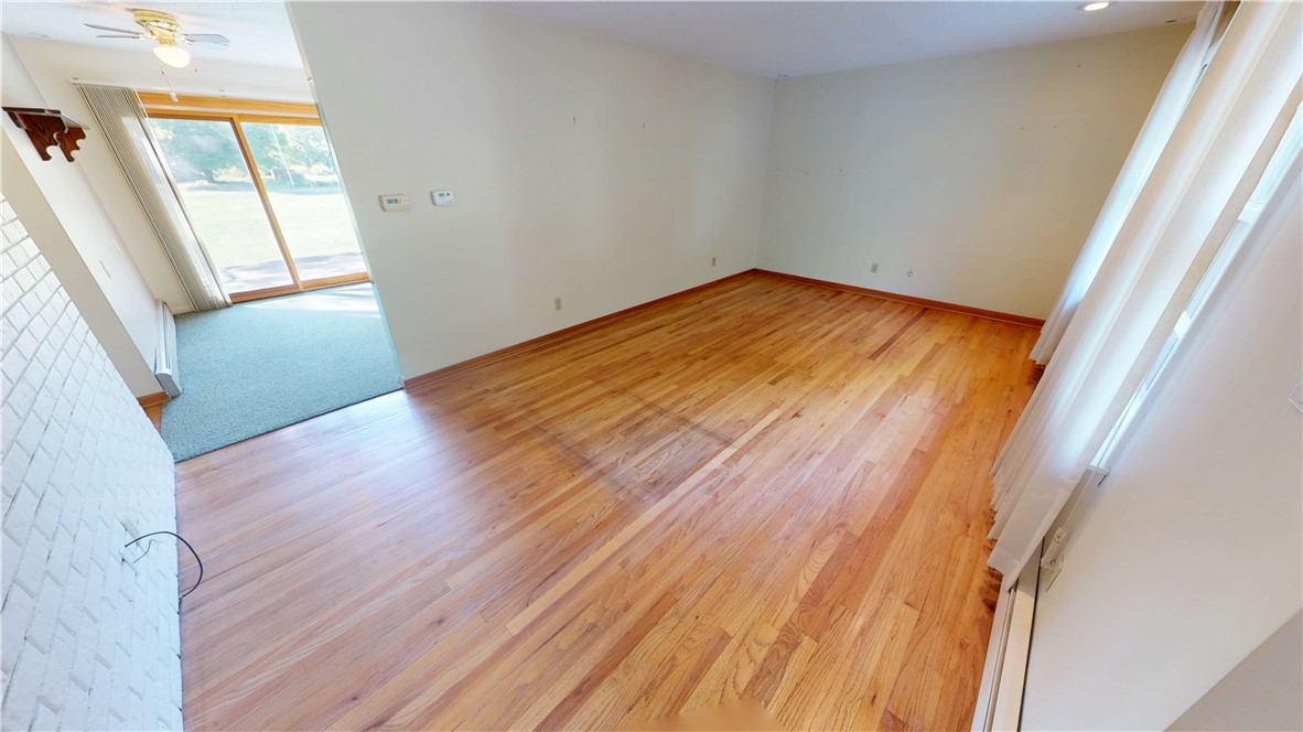 412 Panola Street Georgetown, IL 61846 - Photo 23 of 42 an empty room with wooden floor and windows
