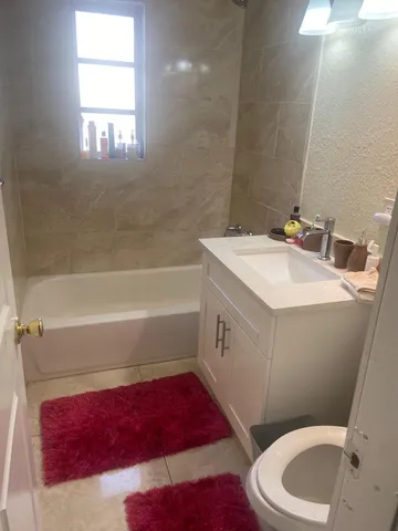 a bathroom with a sink a toilet and bathtub