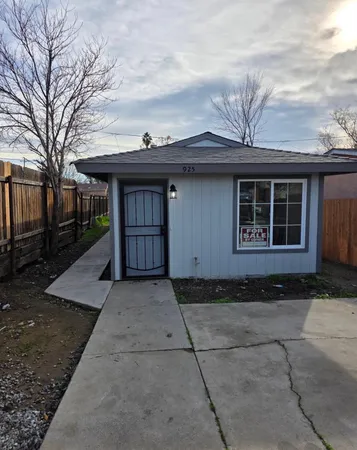 a front view of a house with a garden
