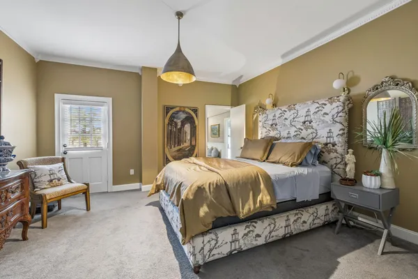 a bed room with a bed and a chair