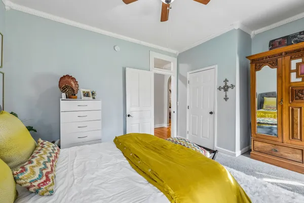 a bedroom with a bed and a chandelier