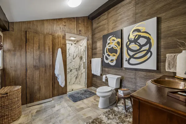 a bathroom with a toilet sink and shower